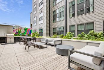 a communal patio with seating and tables in front of a building at Coda at Bryant Street, District of Columbia 